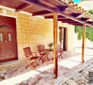 a patio with a table and chairs and a door at Irini Studios in Alykes