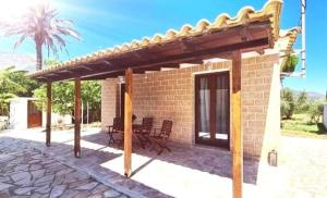 a pavilion with a table and chairs on a patio at Irini Studios in Alykes