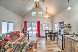 a kitchen and living room with a couch and a table at Kalispell Cabin 28 Miles to Glacier National Park! in Kalispell