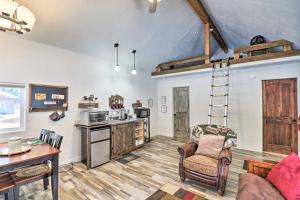 a living room with a kitchen and a loft at Kalispell Cabin 28 Miles to Glacier National Park! in Kalispell