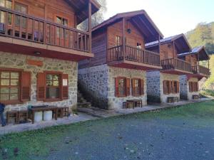 a large building with balconies and tables in front of it at Mencuna Konaklari in Arhavi