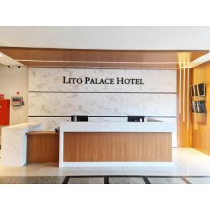 a lobby of a hotel with a sign that reads into palace hotel at Lito Palace Hotel in Registro