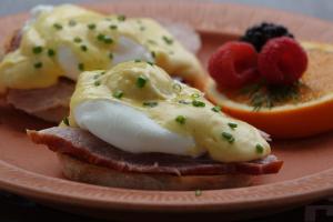a plate of food with eggs and fruit on it at Ray's Bucktown Bed and Breakfast in Chicago