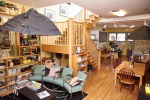 a woman sitting in a chair in a restaurant at Ray's Bucktown Bed and Breakfast in Chicago