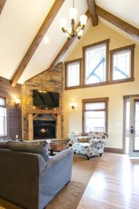 a living room with couches and a fireplace at Country Bliss Cottage by Amish Country Lodging in Berlin