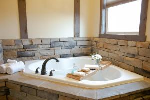 a bathroom with a bath tub with a sink at Country Bliss Cottage by Amish Country Lodging in Berlin