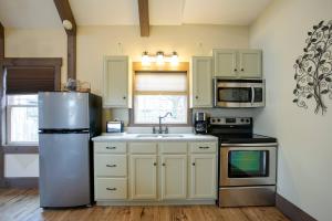 A kitchen or kitchenette at Country Bliss Cottage by Amish Country Lodging