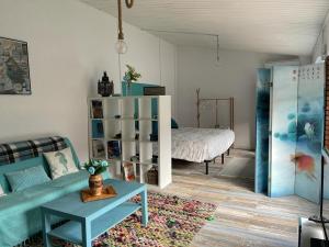 ein Wohnzimmer mit einem Sofa und einem Bett in der Unterkunft Raconet Azul - Circuito Cataluña in Vallromanas