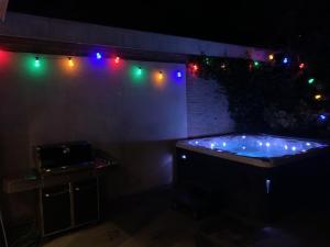 a dark room with a tub with christmas lights at Villa Cosy Central incl Jacuzzi Near trainstation, beach and city in Heemstede