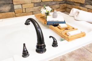 a kitchen sink with a black faucet at Village Dreams Cottage by Amish Country Lodging in Berlin