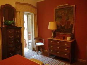 a bedroom with a dresser and a painting on the wall at Estrela Park in Lisbon