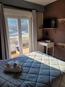 1 dormitorio con 1 cama grande y toallas. en Logis Hôtel Restaurant L'Escapade, en Le Crestet
