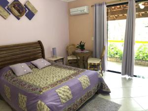 ein Schlafzimmer mit einem Bett und einem Tisch mit Stühlen in der Unterkunft Pousada Canto das Corujas in São Roque + 43 Fotos