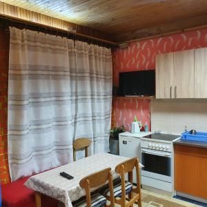 una pequeña cocina con mesa y sillas. en Apartman "Athos" prizemlje, en Višegrad