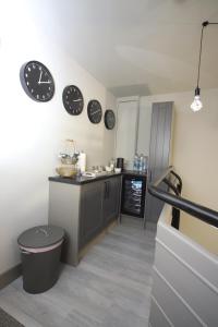 a kitchen with clocks on the wall and a counter at No 1 Bank Chambers in Sleaford