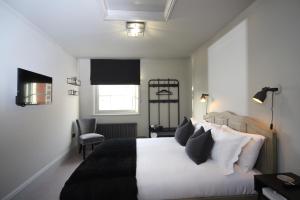 a bedroom with a bed with black and white pillows at No 1 Bank Chambers in Sleaford