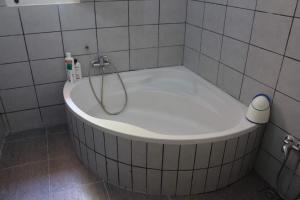 a bath tub in a tiled bathroom with a shower at Villa luxueuse meublée in Sfax +20 photos