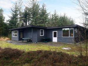 a small blue house with a picnic table in a yard at Charming Cottage near Beach - By Traum Ferienwohnungen in Fjerritslev
