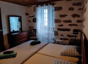 Postel nebo postele na pokoji v ubytování Casinha dos cinco sentidos