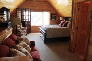 a bedroom with a bed and a couch in a room at A River Runs Through It in Sevierville +46 photos