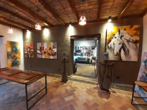 a room with paintings of a horse on the wall at Hostal Suite Le Fabrique in Cuenca