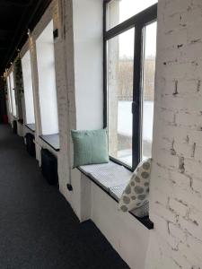 a window seat in a room with a green pillow at SHELTERZ Электрозаводская in Moscow