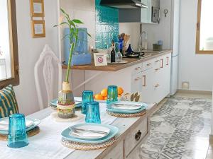 a kitchen with blue dishes on a table at Casa Bakara in Vejer de la Frontera