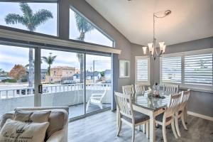 a dining room with a table and chairs and windows at Ideally Located Ocean Escape Near Beach and Wineries in Grover Beach
