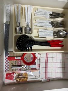 a drawer filled with lots of utensils at Apartman Bonaca in Niš