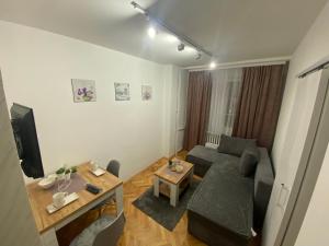 a living room with a couch and a table at Apartman Bonaca in Niš