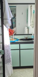 a kitchen with white cabinets and a sink at Hilo Luxury Suite in Hilo