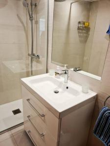 埃斯特波納的住宿－Estepona port beachside apartment - Marina Bay，浴室配有白色水槽和淋浴。