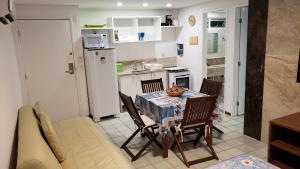 a kitchen and dining room with a table and chairs at Ancorar Resort Vista Mar Flat 6103 in Porto De Galinhas