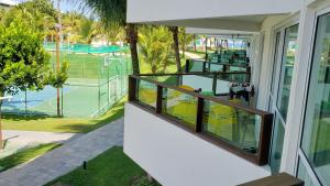un balcon avec vue sur un court de tennis dans l'établissement Ancorar Resort Frente Mar - Flat 6103, à Porto de Galinhas