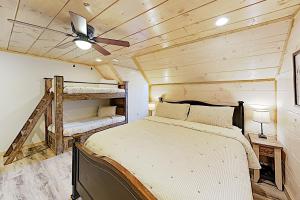a bedroom with a bed and a ceiling fan at Bear Cove Falls in Pigeon Forge
