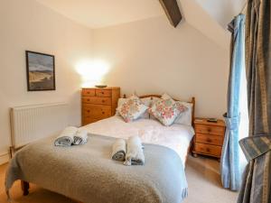 a bedroom with a bed with towels on it at Edrydd in Harlech +16 photos
