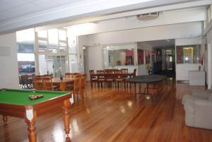 a living room with a pool table and chairs at Port Adelaide Backpackers in Adelaide