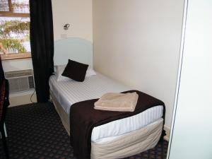 Grand Tasman Hotel tesisinde bir odada yatak veya yataklar