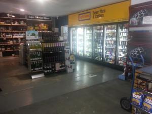 a store aisle of a grocery store with shelves of products at Grand Tasman Hotel in Port Lincoln