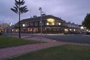 a large building on a city street at night at Grand Tasman Hotel in Port Lincoln