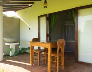 a table and two chairs on a patio at Wild Edge - Wilpattu Safari Stay in Nochchiyagama
