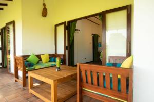 a living room with a couch and a table at Wild Edge - Wilpattu Safari Stay in Nochchiyagama