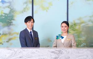 a man and a woman standing behind a table at Keisei Richmond Hotel Tokyo Kinshicho in Tokyo