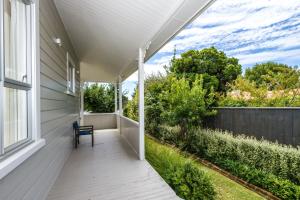 a porch with a table and a chair on a house at Corokia Villa - Peaceful, Modern Villa in Richmond in Richmond +32 photos