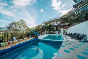 a pool at a resort with a swimming pool at Skylodge Resort in Coron
