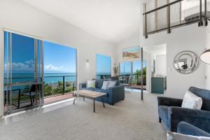 a living room with a view of the ocean at Ocean Spa Views in Nelson