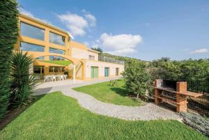 a large yellow house with a grass yard at Casa das Oliveiras - OLIVE TREE in Monchique