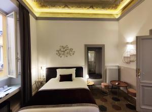 Un ou plusieurs lits dans un hébergement de l'établissement Visconti Suites by FNA Hospitality Roma