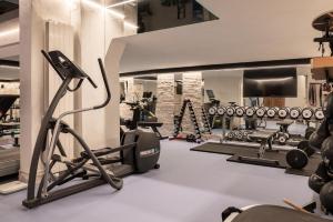 a fitness room with a gym with a treadmill and weights at Boutique Hotel Albana Real - Restaurants & Spa in Zermatt +37 photos