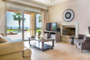 a living room with a couch and a tv and a fireplace at Alegria in Minia